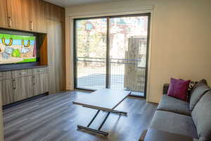 Living area featuring dark wood-type flooring and baseboards