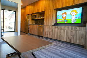 Kitchen featuring stainless steel appliances and dark countertops