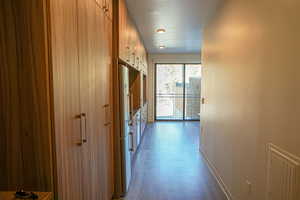 Hallway featuring baseboards and dark wood finished floors