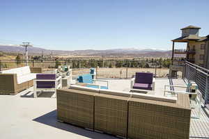 View of patio featuring an outdoor hangout area and a mountain view