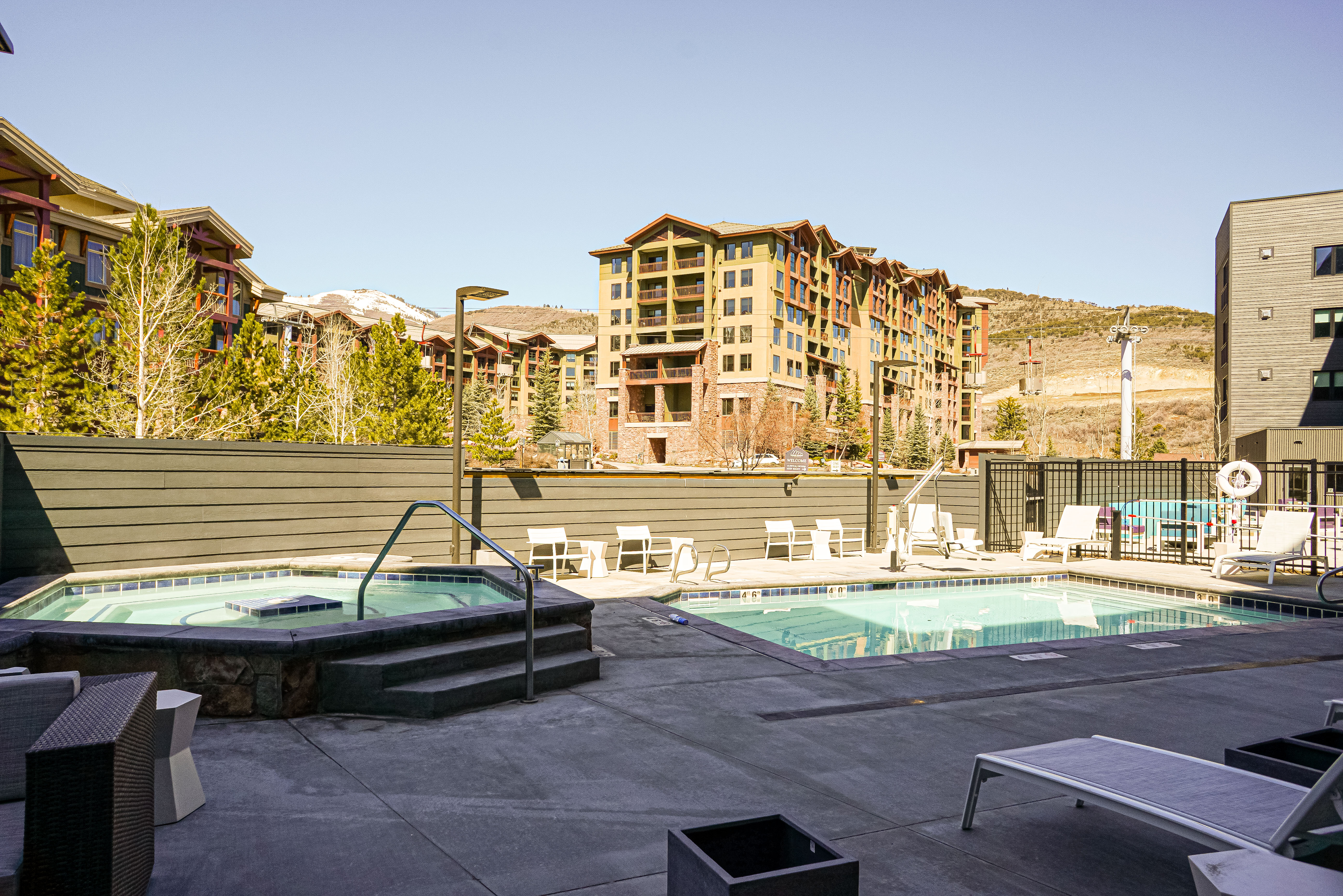 Community pool with a hot tub and a patio area