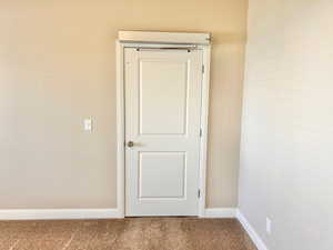 Detailed view of carpet and baseboards