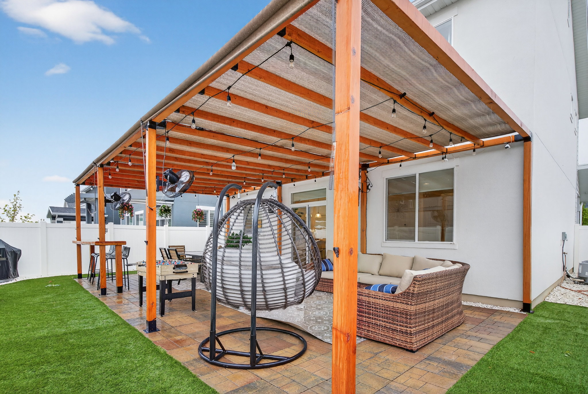 Fenced backyard with an outdoor hangout area, a patio area, and area for grilling