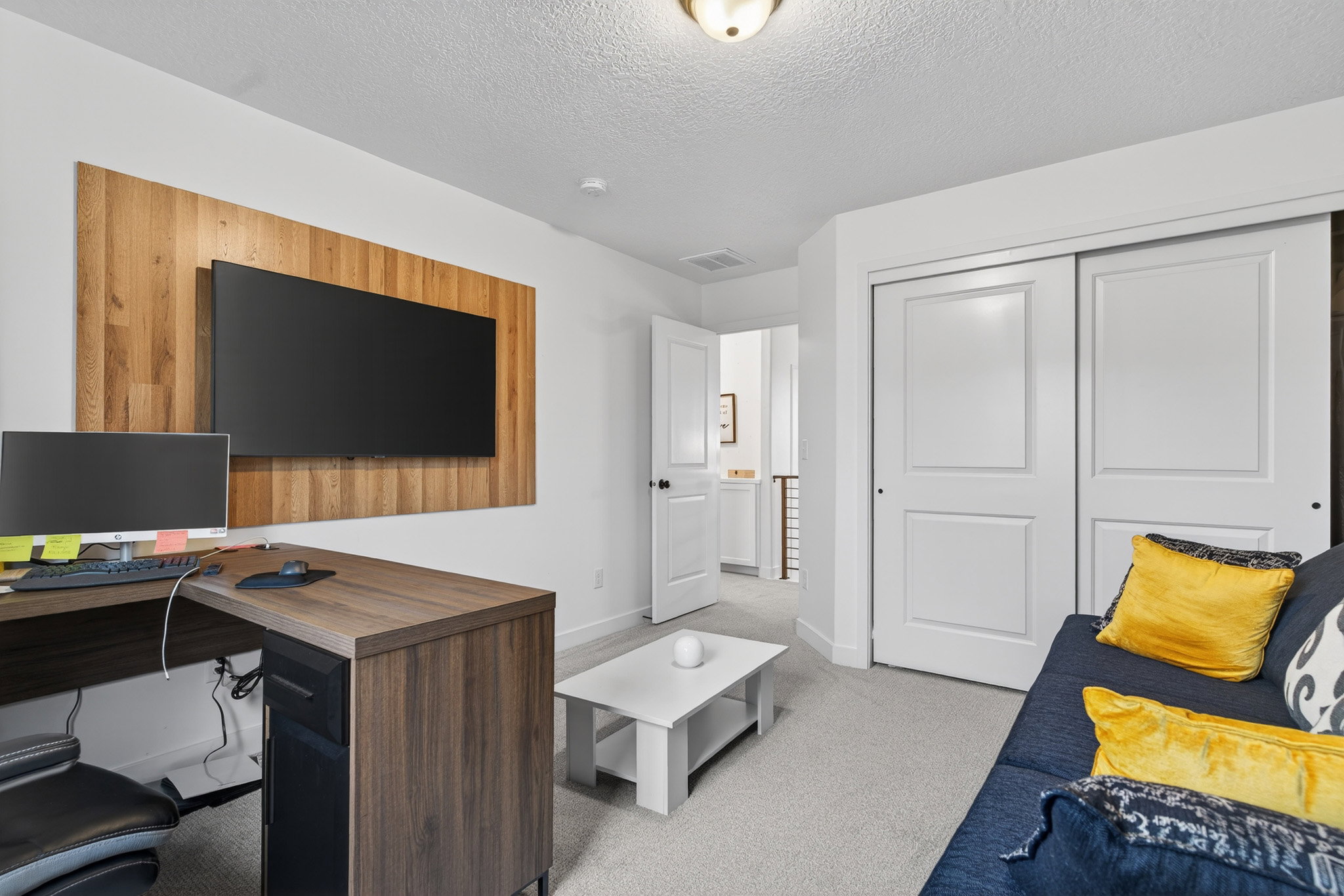 Office area featuring light colored carpet and a textured ceiling