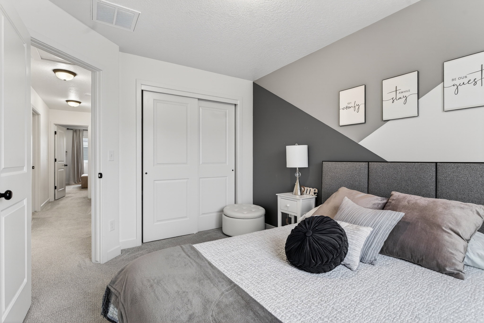 Carpeted bedroom featuring a closet and a textured ceiling