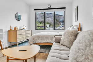 Bedroom featuring wood finished floors and a mountain view