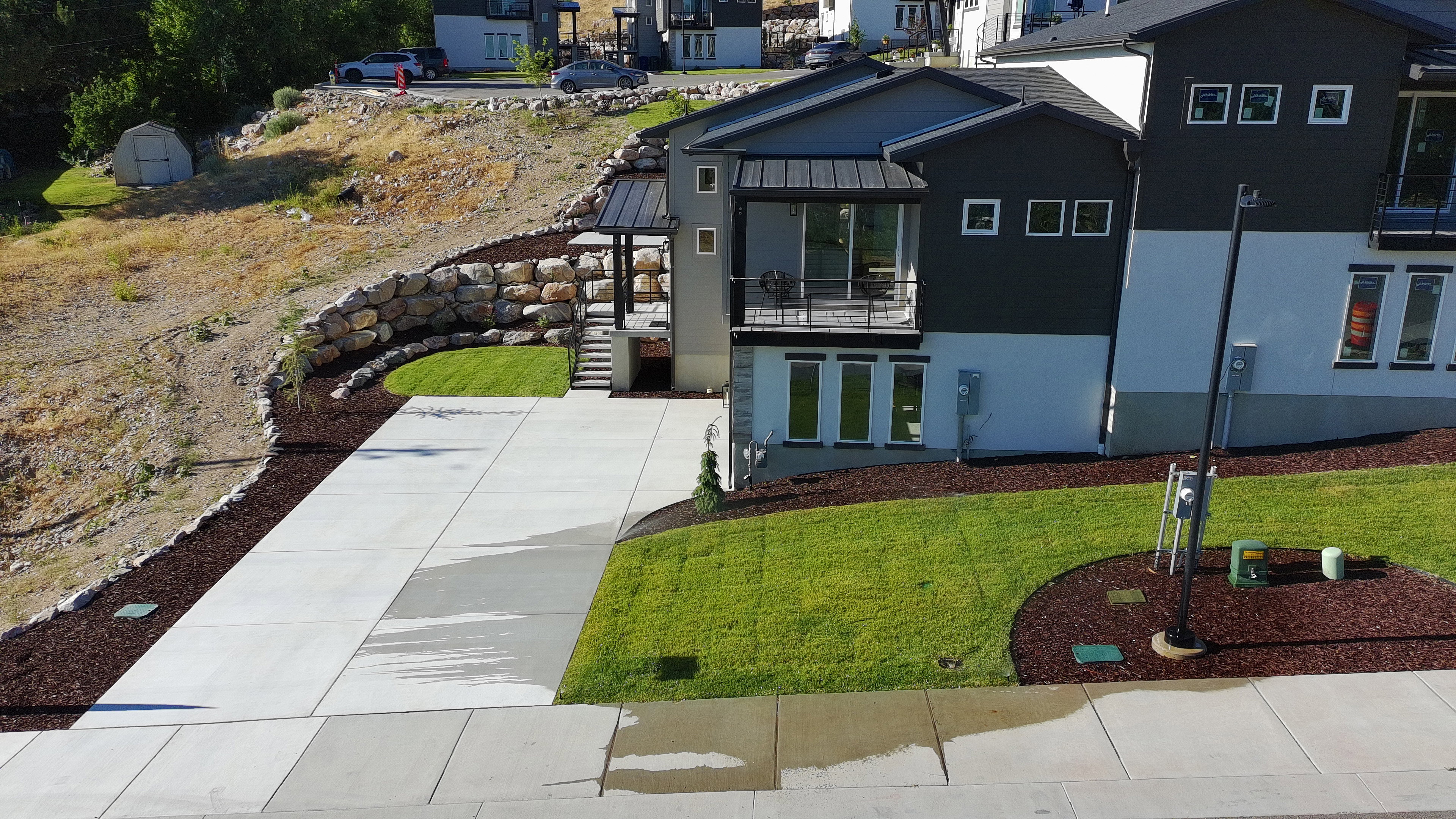 Modern architecture with a multi-level design and a combination of white and dark gray siding