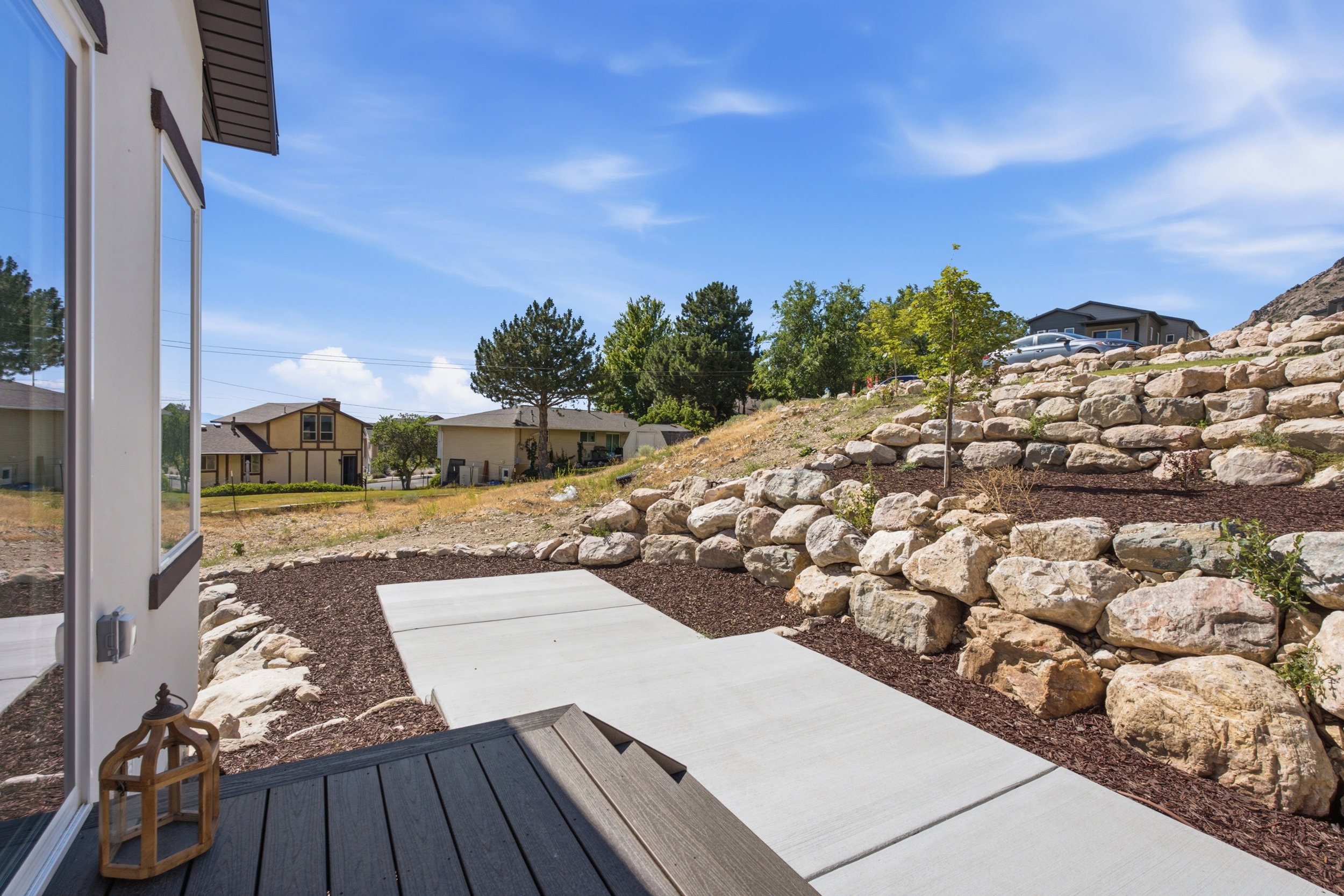 Terraced landscaping featuring large rocks and mulch