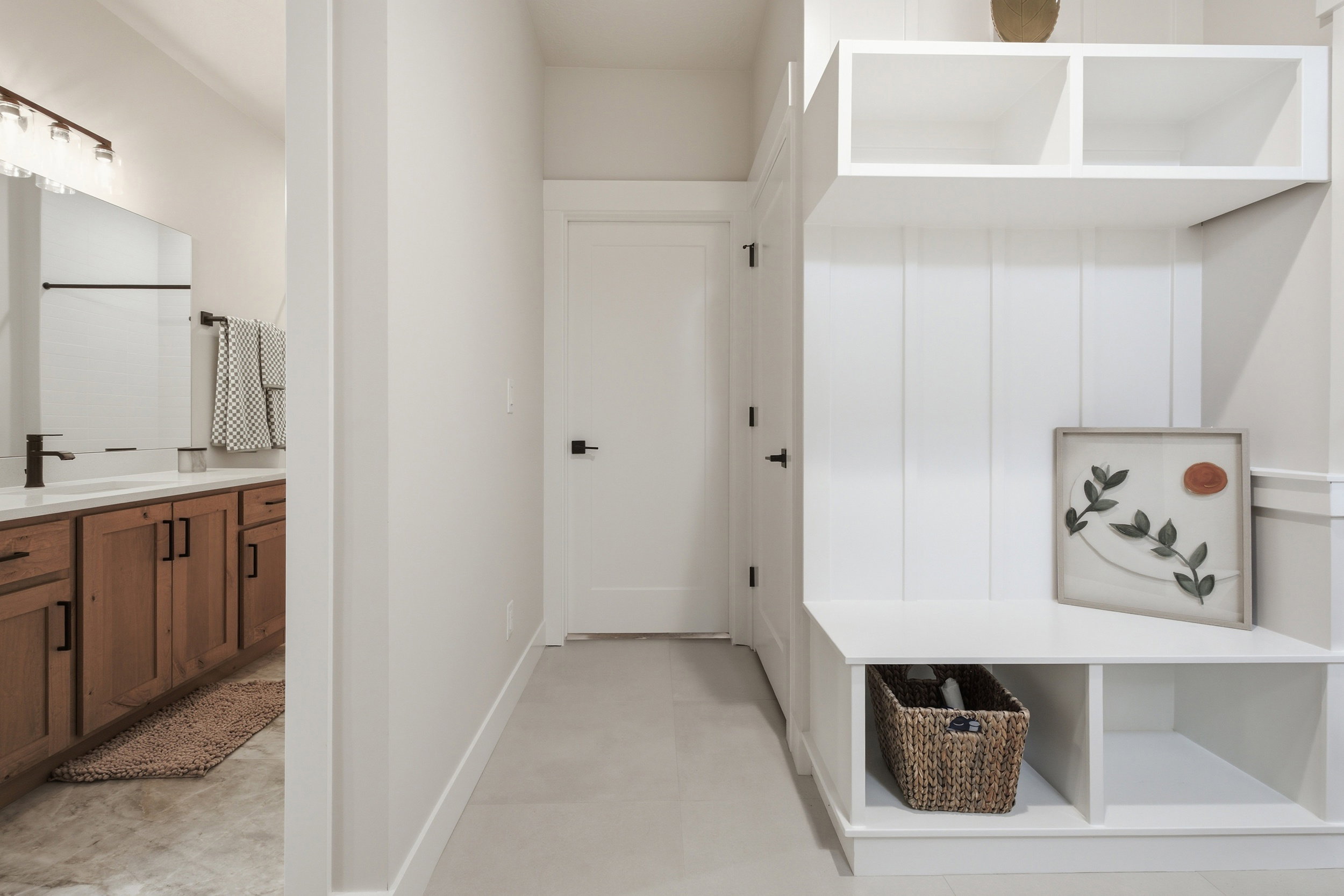 Built-in white storage bench with upper shelving and beadboard detailing