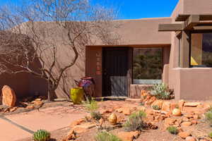 Property entrance featuring stucco siding