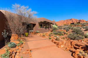 View of front of house with stucco siding and a mountain view