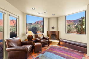 Tiled cinema room featuring recessed lighting and a fireplace with raised hearth