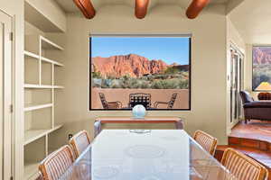 Dining room featuring a mountain view and vaulted ceiling with beams