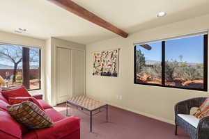 Living room featuring a mountain view, beamed ceiling, carpet flooring, and recessed lighting