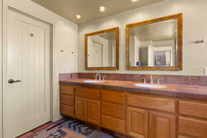 Full bath featuring double vanity and recessed lighting
