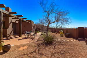 Fenced backyard featuring a patio area, outdoor dining space, and a pergola