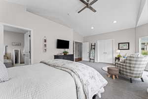Bedroom featuring a closet, lofted ceiling, recessed lighting, dark colored carpet, and a ceiling fan