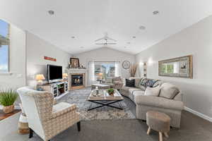 Living area with baseboards and a glass covered fireplace