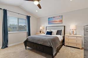 Bedroom featuring light carpet, lofted ceiling, a ceiling fan, and recessed lighting