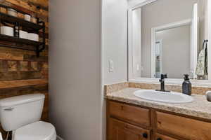 Half bathroom with toilet and vanity