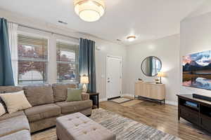 Living area with light wood-type flooring and baseboards