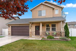 Craftsman-style house featuring a porch, roof with shingles, stone siding, and an attached garage