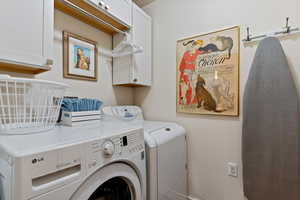 Laundry area with cabinet space and washing machine and dryer