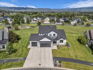 Aerial perspective of suburban area featuring a mountain backdrop