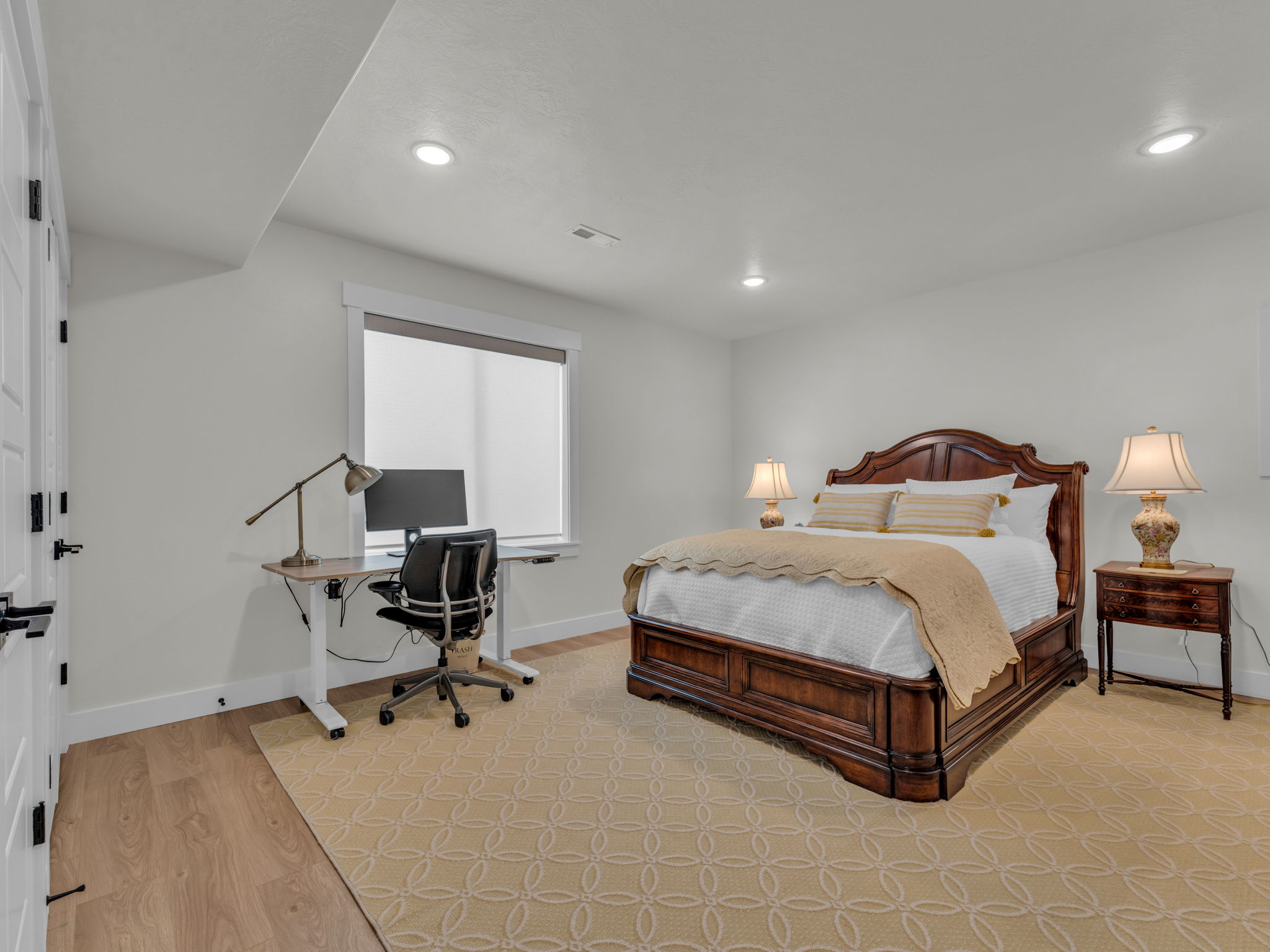 Bedroom featuring an office area, light wood finished floors, and recessed lighting