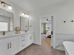 Bathroom with double vanity, ensuite bath, a freestanding bath, and a ceiling fan