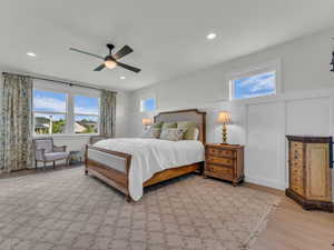 Bedroom with a ceiling fan, light wood-style flooring, and recessed lighting