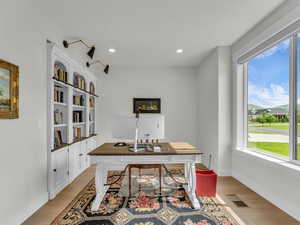 Home office featuring light wood finished floors and recessed lighting