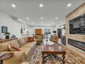 Living area with a fireplace, recessed lighting, and light wood-type flooring