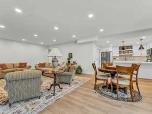Living area featuring light wood-style floors and recessed lighting