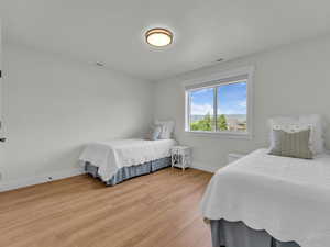 Bedroom featuring light wood-style floors and baseboards