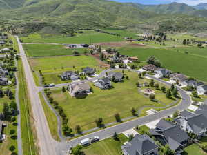 Aerial overview of property's location with nearby suburban area and a mountainous background