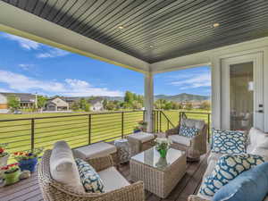 Deck with a lawn and an outdoor living space