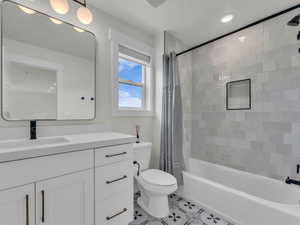 Full bathroom featuring vanity, shower / bath combo, recessed lighting, and light tile patterned flooring