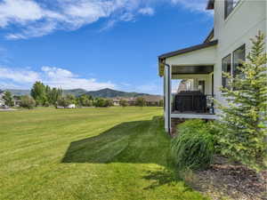 View of grassy yard featuring a mountain view