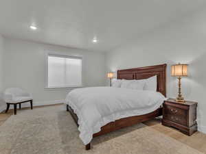 Bedroom with light wood finished floors and recessed lighting