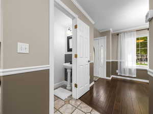 Bathroom featuring ornamental molding and light wood-style flooring