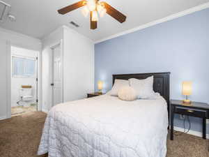 Bedroom featuring carpet, crown molding, and ceiling fan