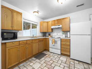 Kitchen with white appliances and light countertops