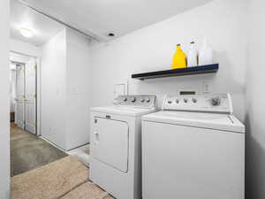 Laundry room featuring independent washer and dryer and concrete floors