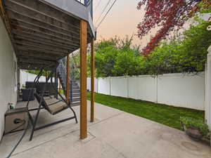 Fenced backyard with a patio area and stairway
