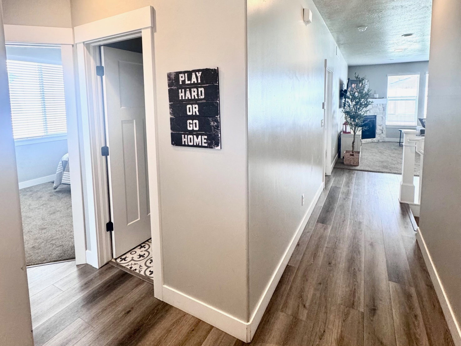 Hallway with dark wood-style flooring, a textured ceiling, and recessed lighting