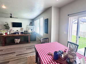Dining space featuring recessed lighting, a textured ceiling, a ceiling fan, and wood finished floors