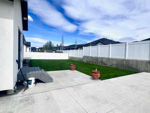 Fenced backyard featuring a patio and a deck
