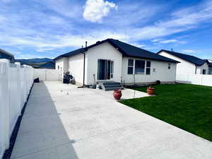 Rear view of house featuring a fenced backyard, a patio area, entry steps, a gate, and stucco siding