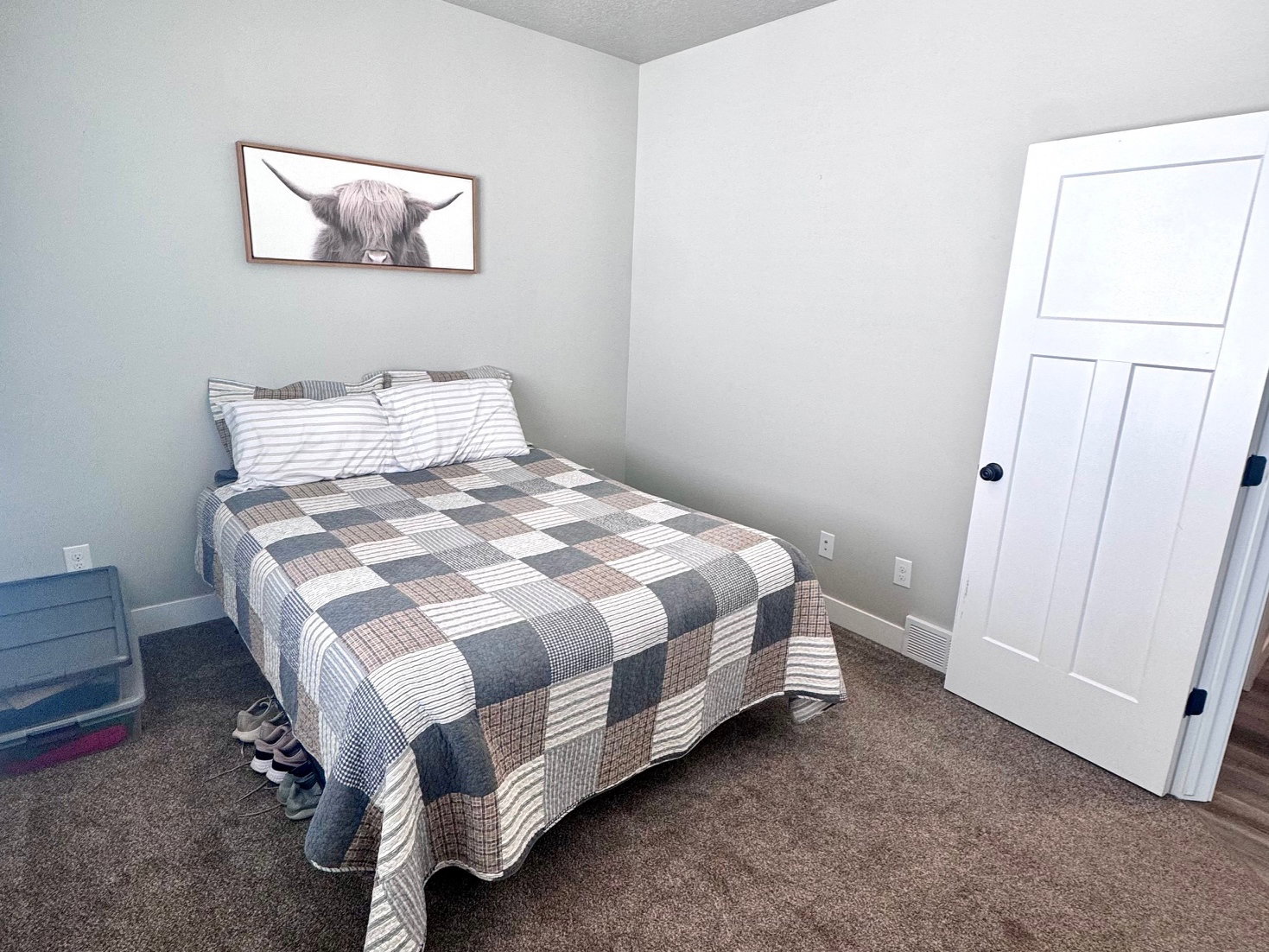 Bedroom with dark carpet and a textured ceiling